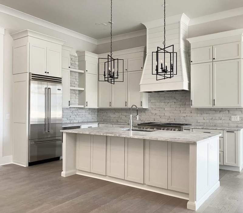 White shaker cabinetry. Quartz countertops.